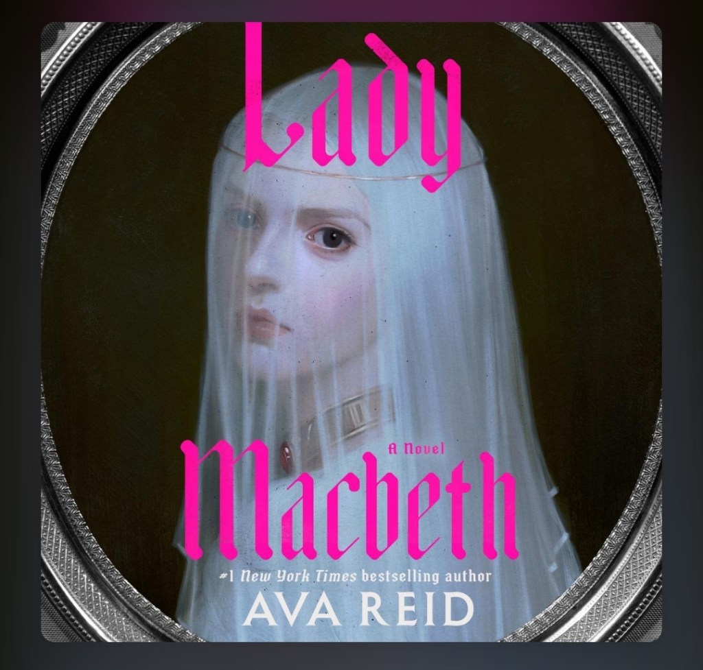 screenshot of Lady Macbeth cover: silver and black rings outline the central image, which is a pale women wearing a sheer white veil. She has a metal necklace with a red gem around her neck, and her dark eye looks directly at the viewer. The title in bright pink is overlaid above and below her face.