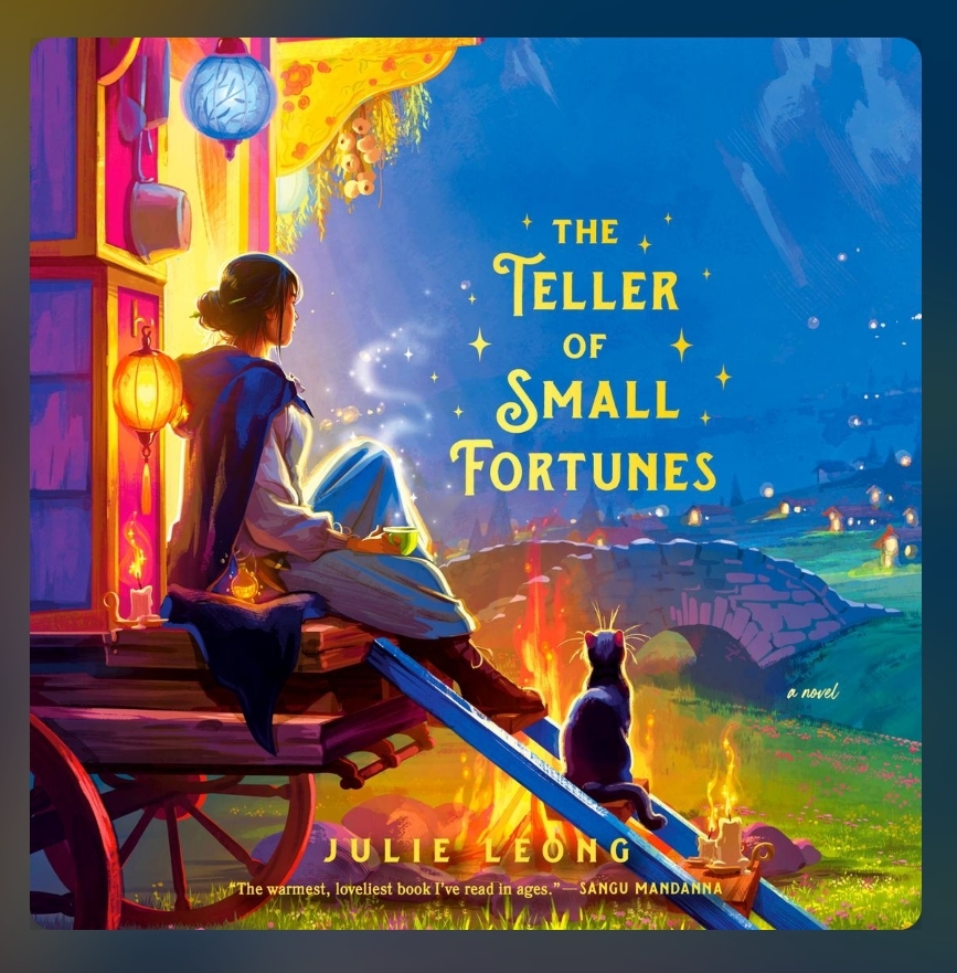 screenshot of Teller of Small Fortunes cover: a deep blue sky serves as the backdrop, with a wagon in the foreground. A young woman sits on the back, looking out across the land toward a nearby stone bridge and distant lights of a town. At her feet there's a cat and a campfire. Everything is cast in a warm golden light from the fire and from the lanterns hanging from her wagon.