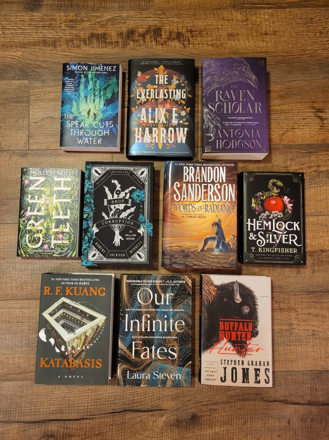 a photo of my top ten reads of the year arranged on the floor, in three rows